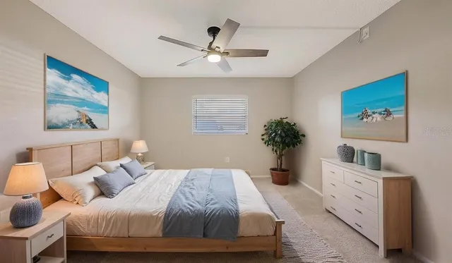 a view of room with a ceiling fan and a window