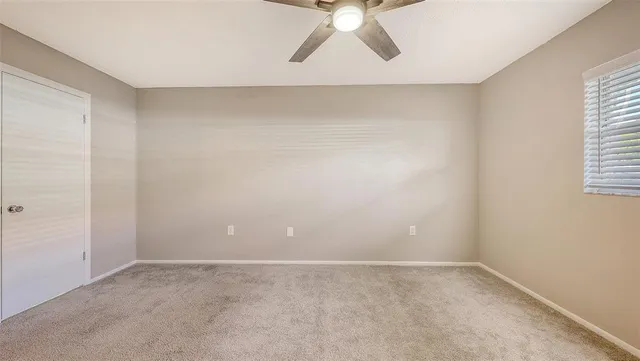 a bathroom with a granite countertop sink a toilet a mirror a bathtub and shower