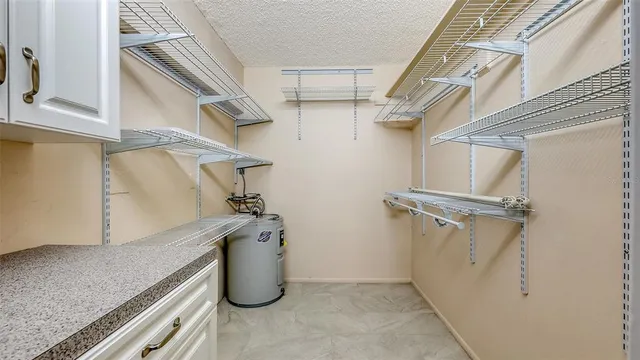 a bathroom with a granite countertop sink a toilet and shower