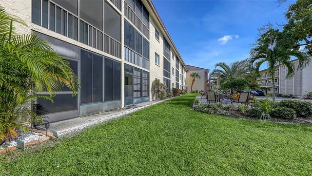 a view of a backyard with table and chairs and potted plants
