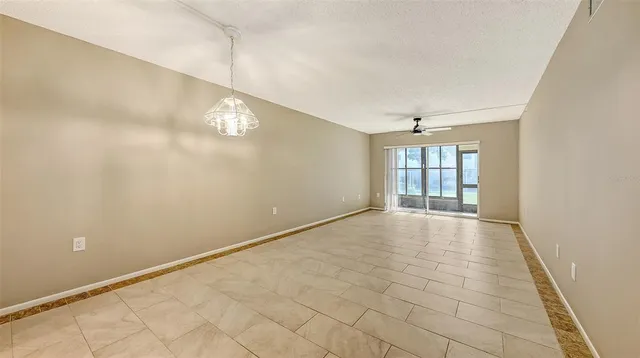 a view of a dining room with furniture a rug and wooden floor