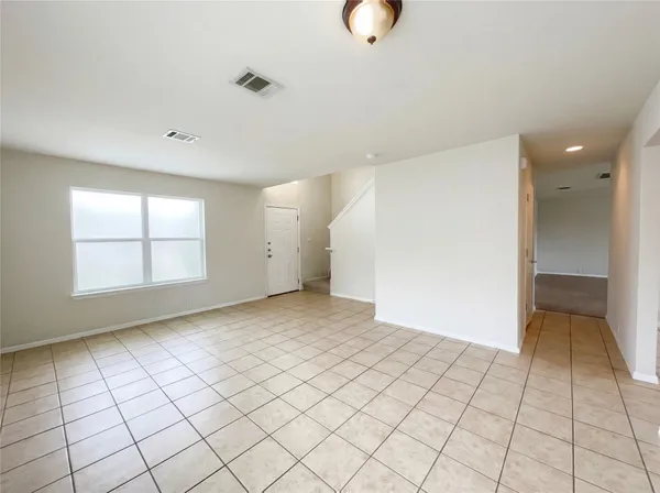 an empty room with windows and painted walls