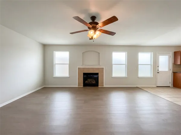 a view of a livingroom with a ceiling fan and window