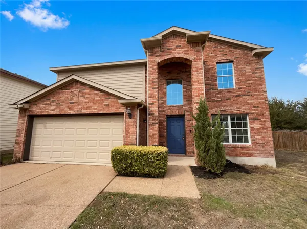 a front view of a house with a garage