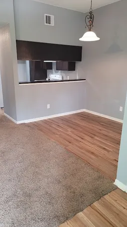 a view of wooden floor and chandelier