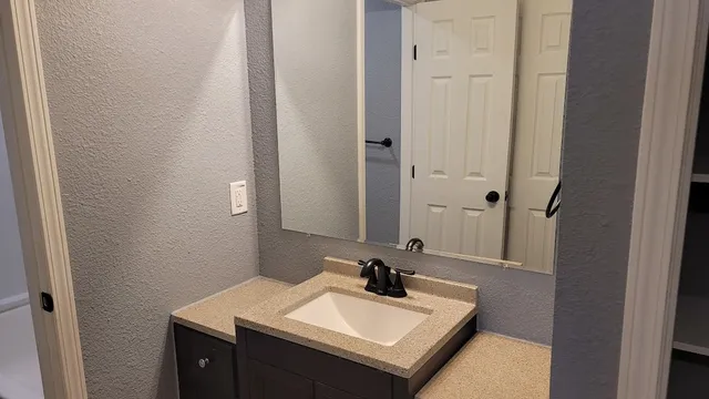 a bathroom with a sink and a mirror