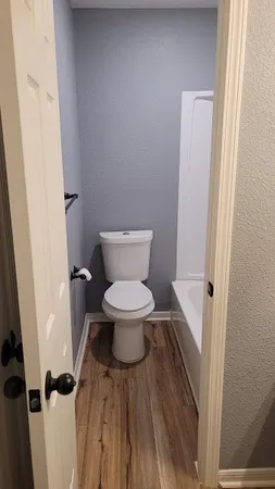 a white toilet sitting next to a sink