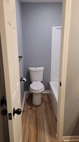 a white toilet sitting next to a sink