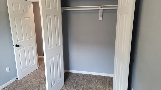 a view of a room with wooden floor