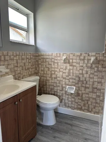 a bathroom with a toilet sink and mirror