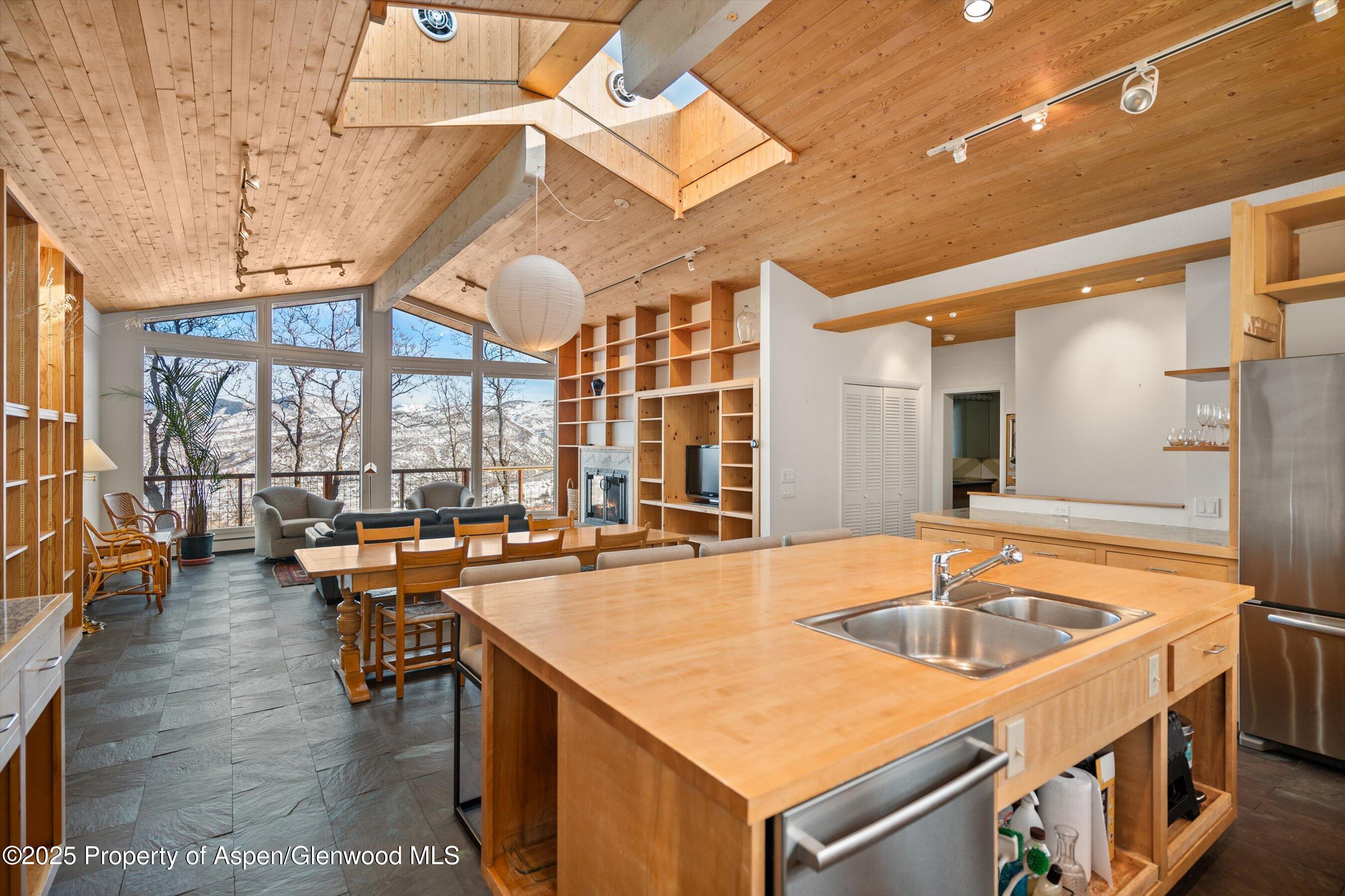 328 Oak Ridge Road Snowmass Village, CO 81615 - Photo 2 of 44 a kitchen that has a sink and a table in it