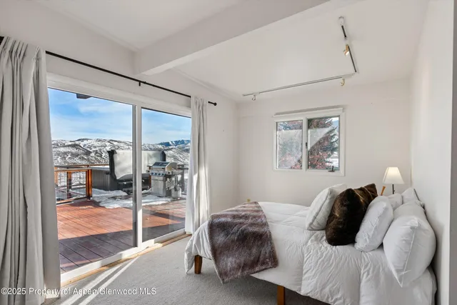 a bathroom with a granite countertop sink a toilet a mirror and shower