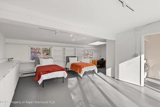 a bedroom with bed and glass door