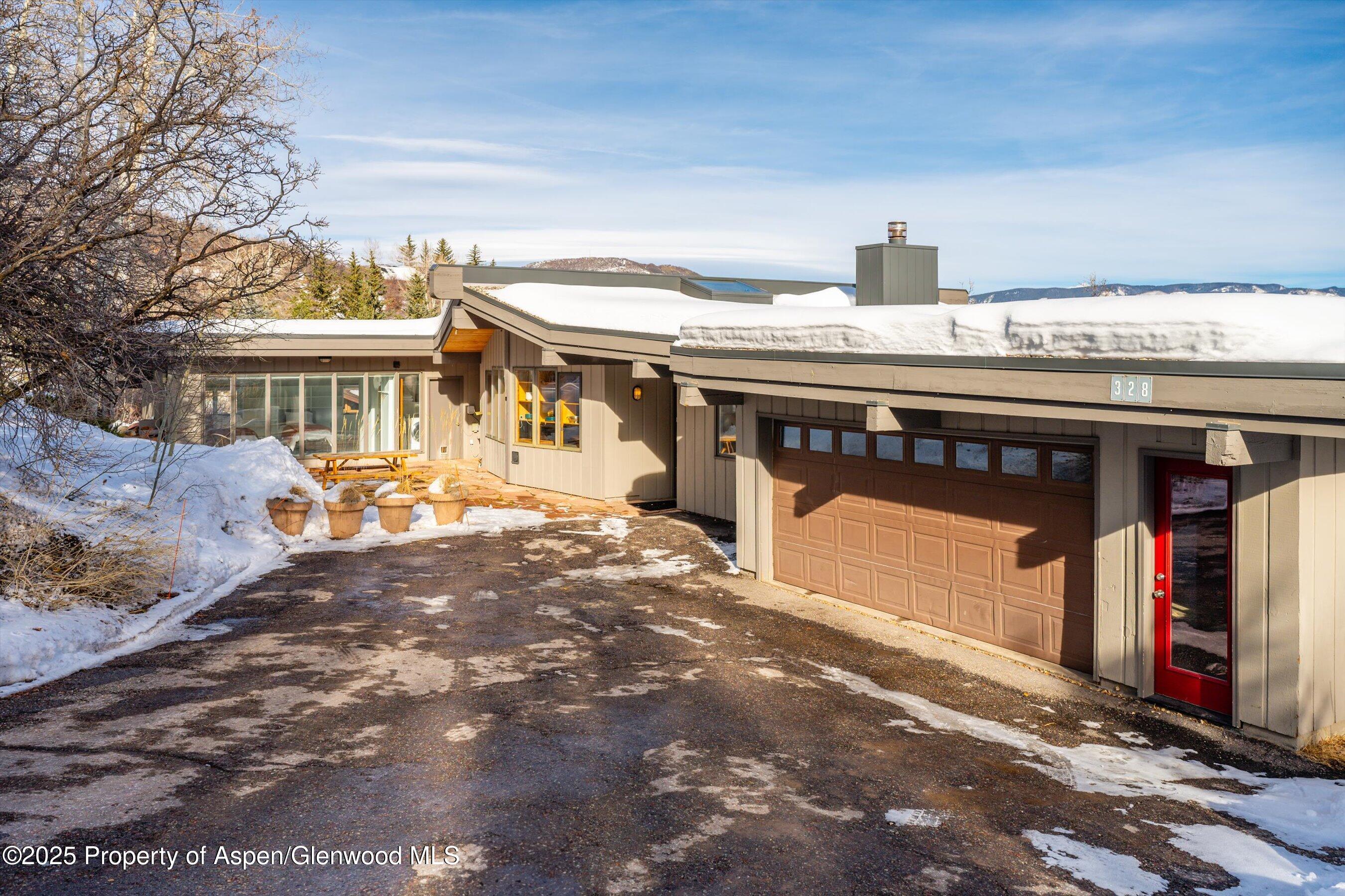 328 Oak Ridge Road Snowmass Village, CO 81615 - Photo 35 of 44 a front view of a house with a yard