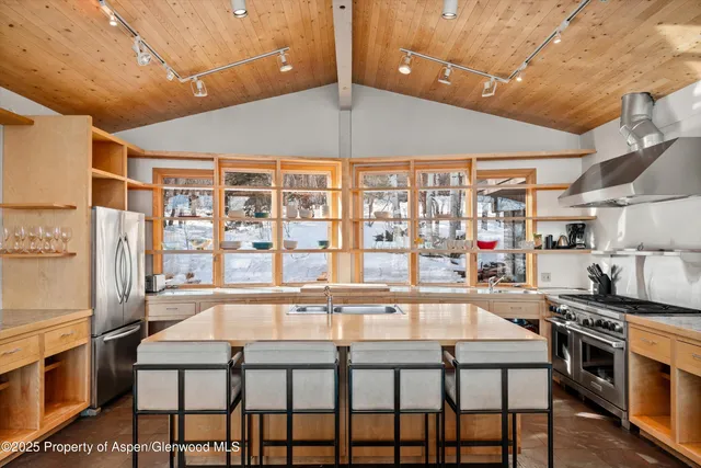 a kitchen with a table chairs stove and cabinets