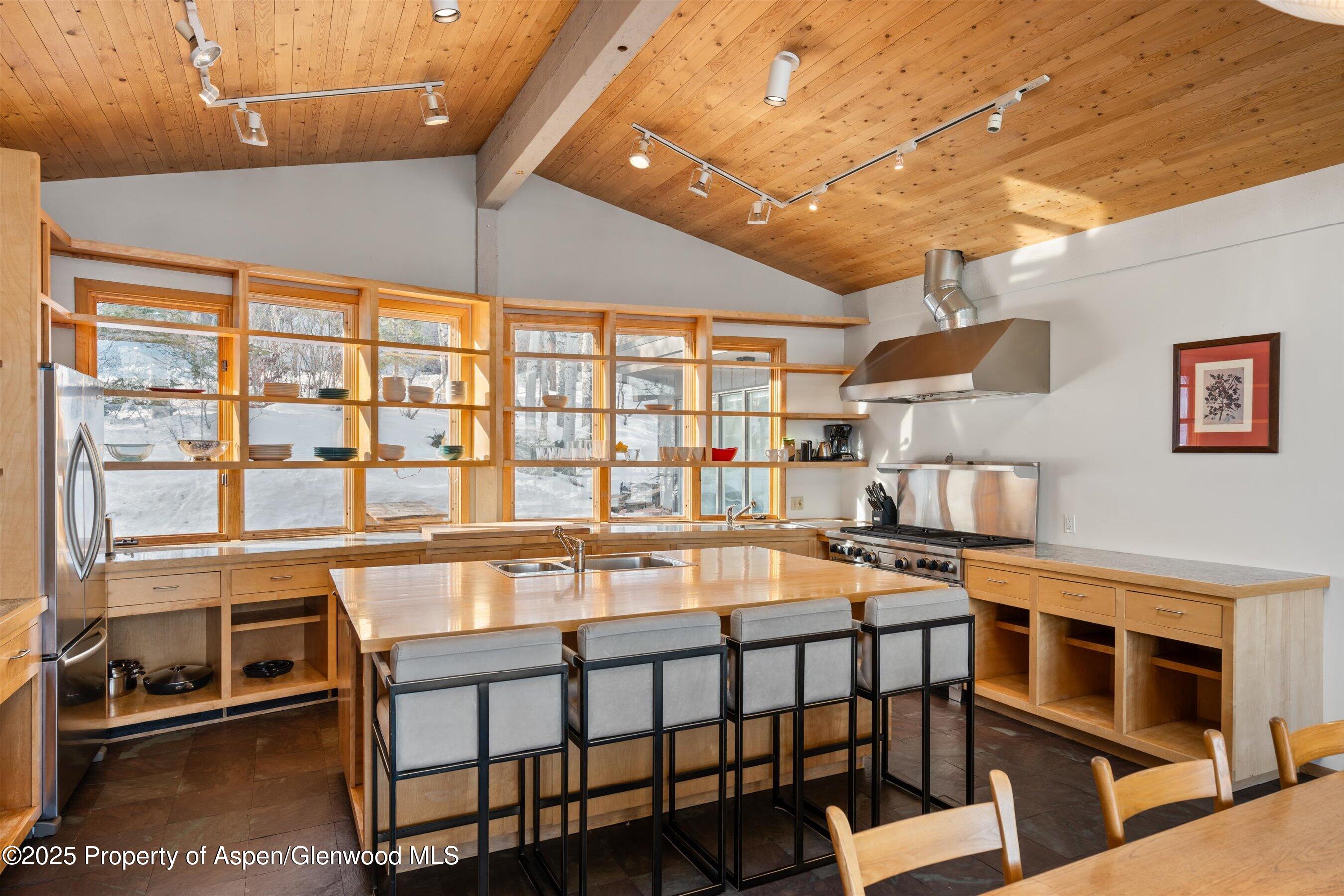 328 Oak Ridge Road Snowmass Village, CO 81615 - Photo 10 of 44 a dining room with stainless steel appliances a table and chairs