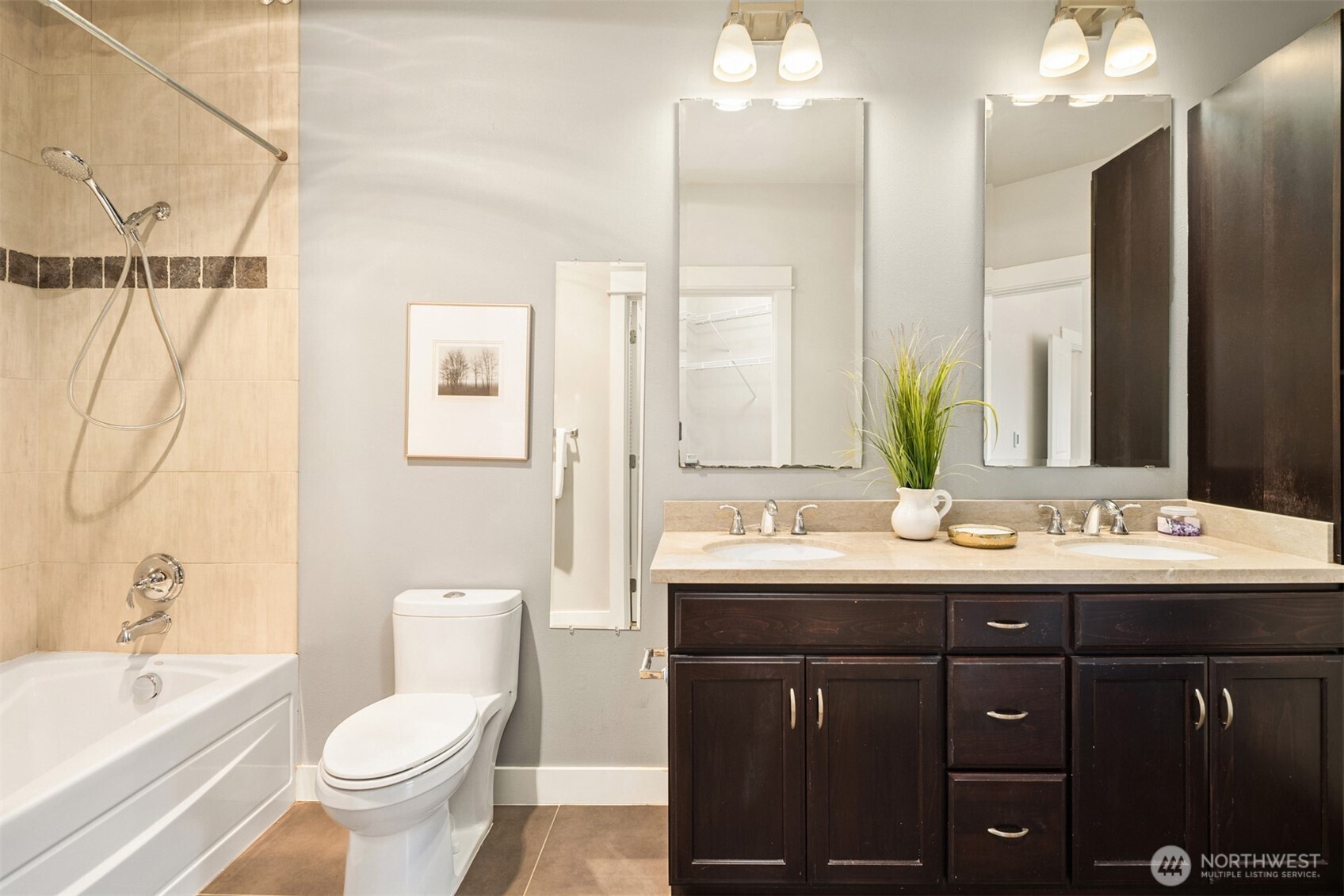15700 116th Avenue Northeast, Unit 404 Bothell, WA 98011 - Photo 23 of 31 a bathroom with a double vanity sink and mirror with toilet
