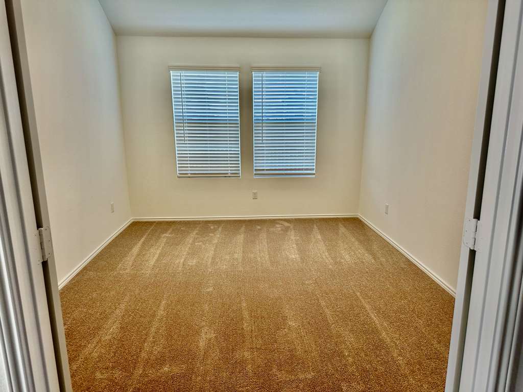 4104 Home Pl Road Georgetown, TX 78628 - Photo 15 of 35 Spare room with light carpet and baseboards