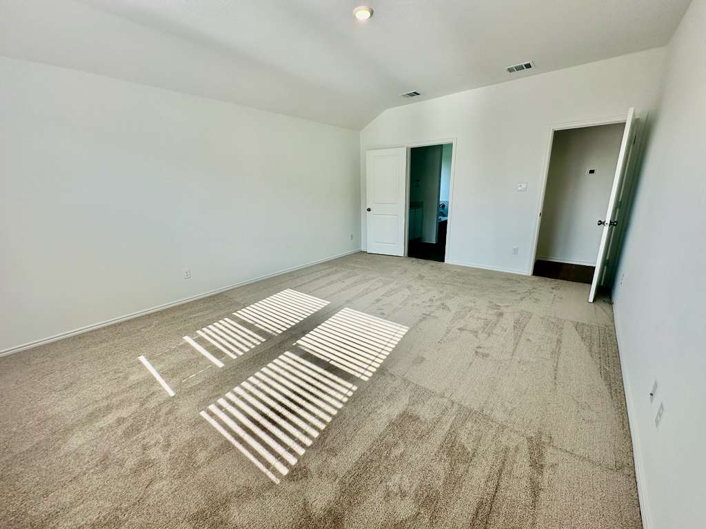 4104 Home Pl Road Georgetown, TX 78628 - Photo 20 of 35 Unfurnished bedroom with light colored carpet and lofted ceiling