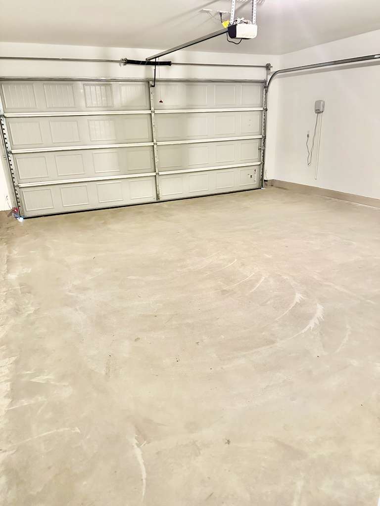 4104 Home Pl Road Georgetown, TX 78628 - Photo 25 of 35 Garage featuring a garage door opener