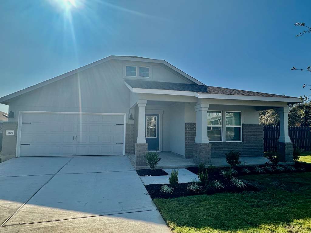 4104 Home Pl Road Georgetown, TX 78628 - Photo 3 of 35 View of front of home with covered porch, brick siding, stucco siding, driveway, and a front yard