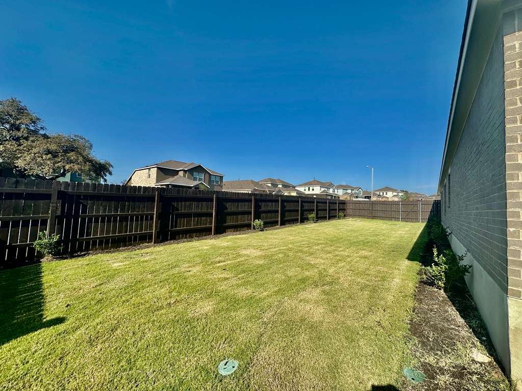 4104 Home Pl Road Georgetown, TX 78628 - Photo 29 of 35 Fenced backyard with a residential view