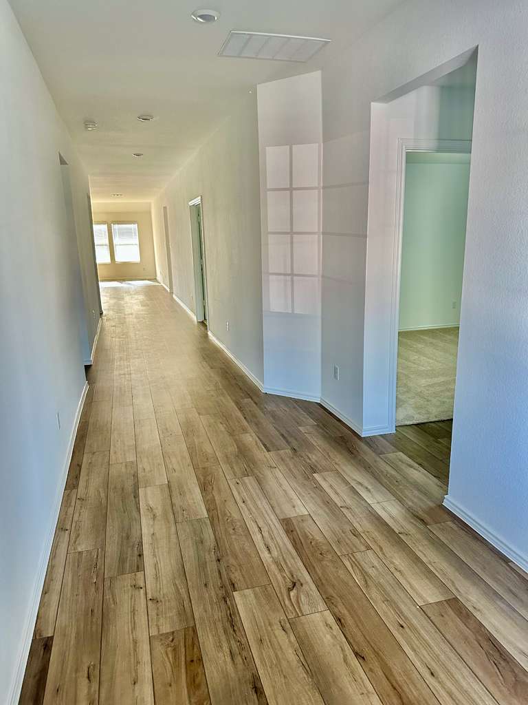 4104 Home Pl Road Georgetown, TX 78628 - Photo 6 of 35 Hallway featuring light wood-style flooring and baseboards