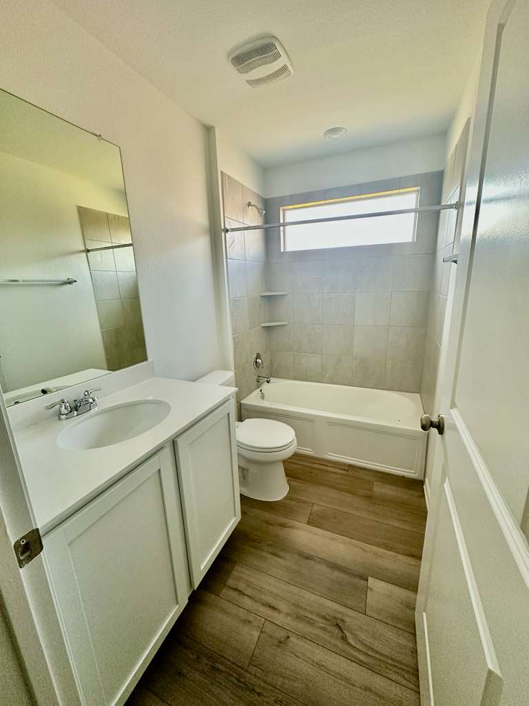 4104 Home Pl Road Georgetown, TX 78628 - Photo 8 of 35 Full bathroom with tub / shower combination, vanity, and dark wood finished floors