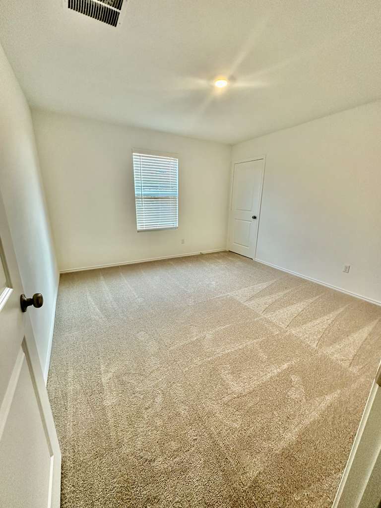 4104 Home Pl Road Georgetown, TX 78628 - Photo 10 of 35 Spare room featuring light colored carpet