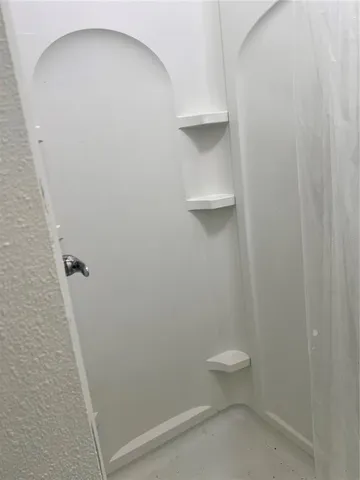 a bathroom with a toilet and a walk in closet