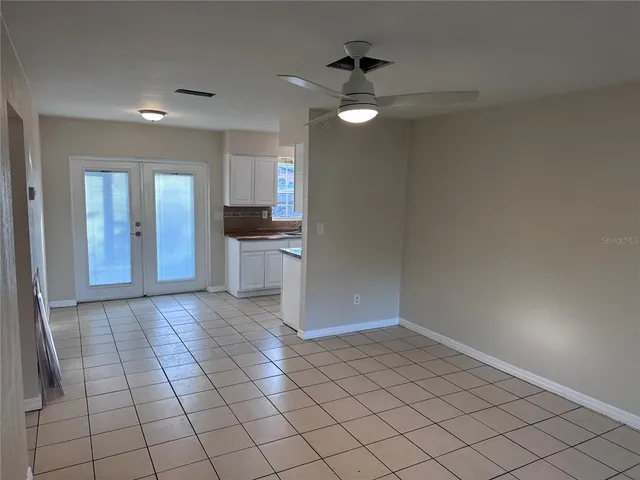 a view of entryway with kitchen and chandelier fan