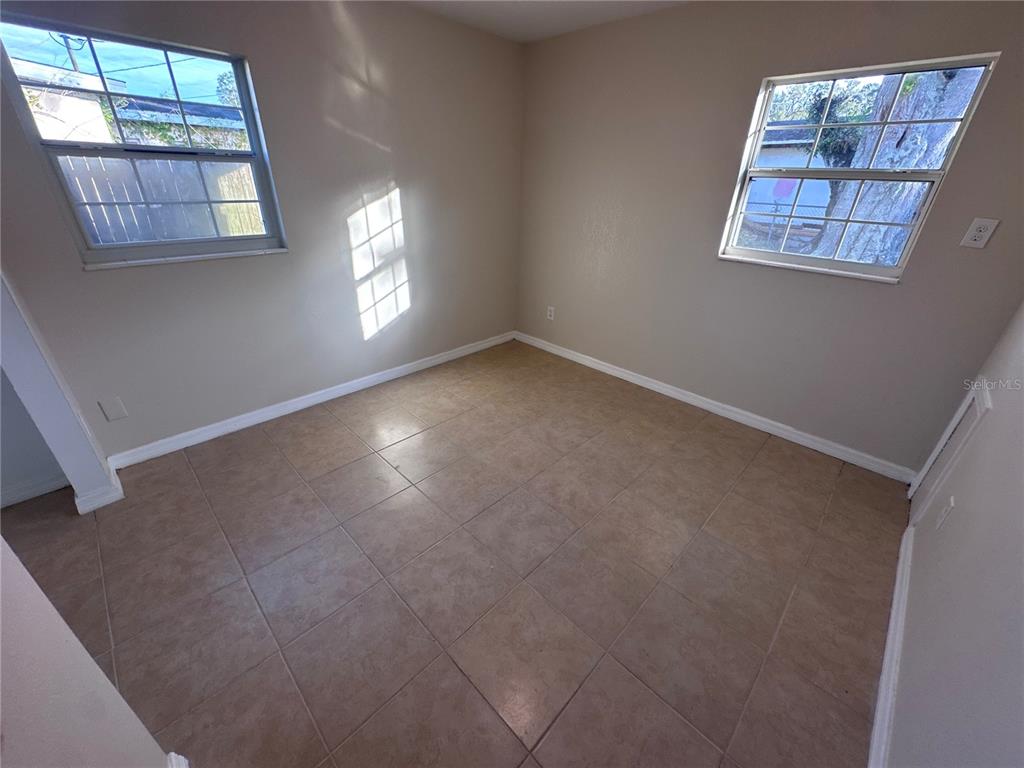 5772 94th Avenue Pinellas Park, FL 33782 - Photo 20 of 29 an empty room with windows and fan