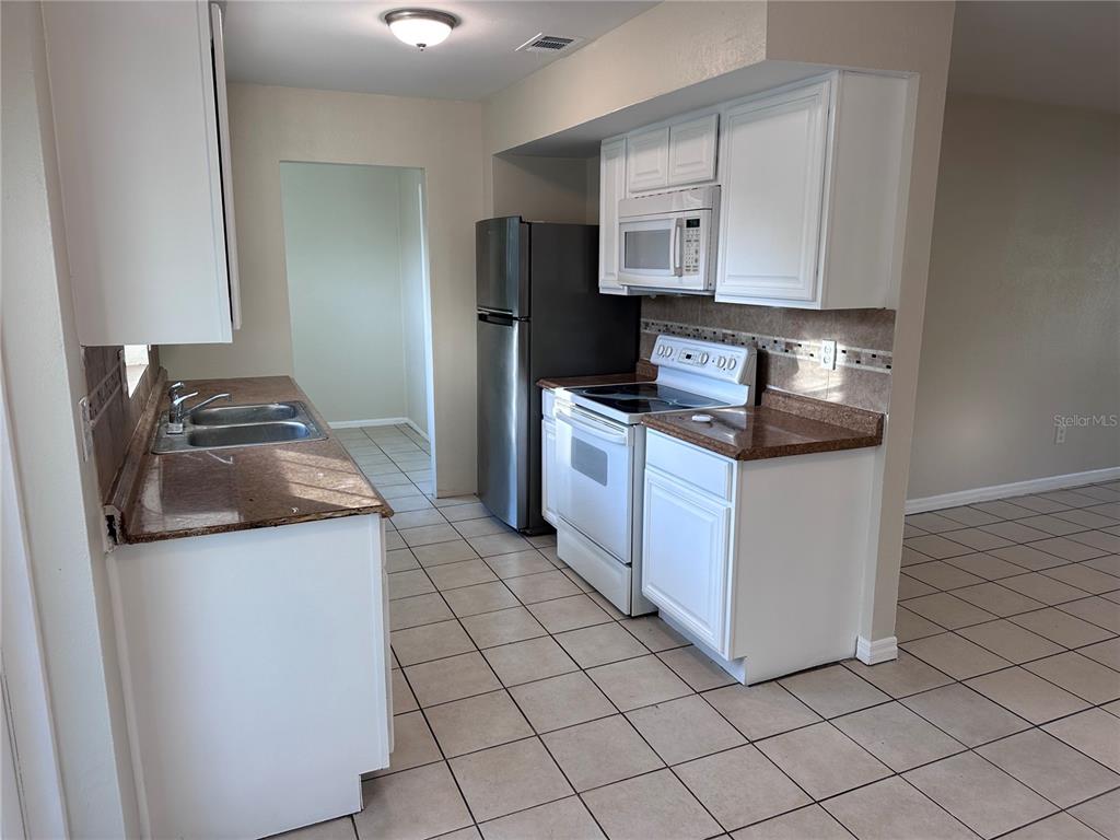 5772 94th Avenue Pinellas Park, FL 33782 - Photo 4 of 29 a kitchen with stainless steel appliances granite countertop a sink and a stove