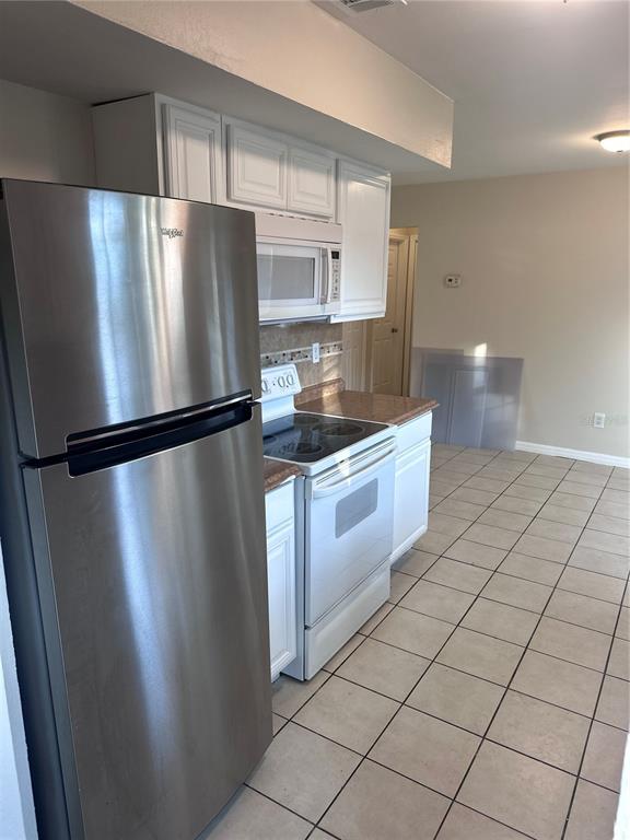 5772 94th Avenue Pinellas Park, FL 33782 - Photo 10 of 29 a kitchen with stainless steel appliances granite countertop a refrigerator and a sink