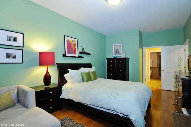 69 East 16th Street, Unit 2 Chicago, IL 60616 - Photo 11 of 16 a bedroom with a bed and wooden floor