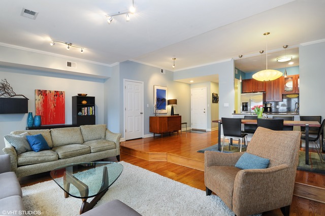 69 East 16th Street, Unit 2 Chicago, IL 60616 - Photo 5 of 16 a living room with furniture kitchen view and a chandelier