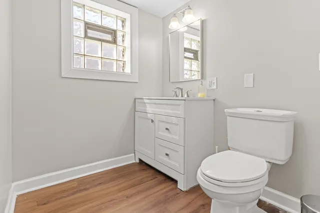 a bathroom with a toilet sink and window