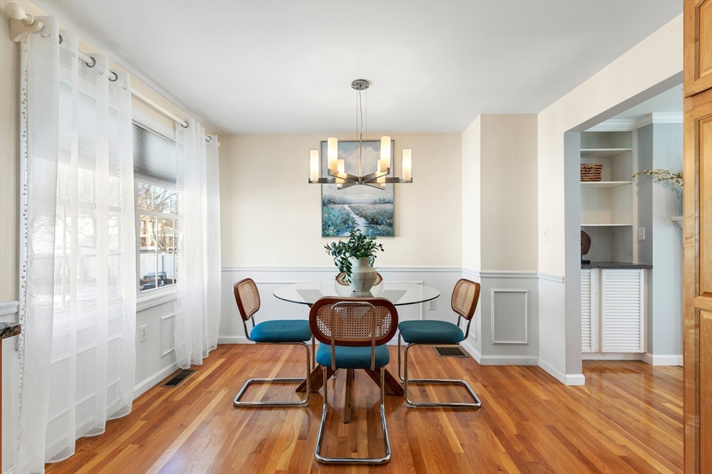 1005 Trapelo Road, Unit 8 Waltham, MA 02452 - Photo 5 of 24 a view of a dining room with furniture and wooden floor