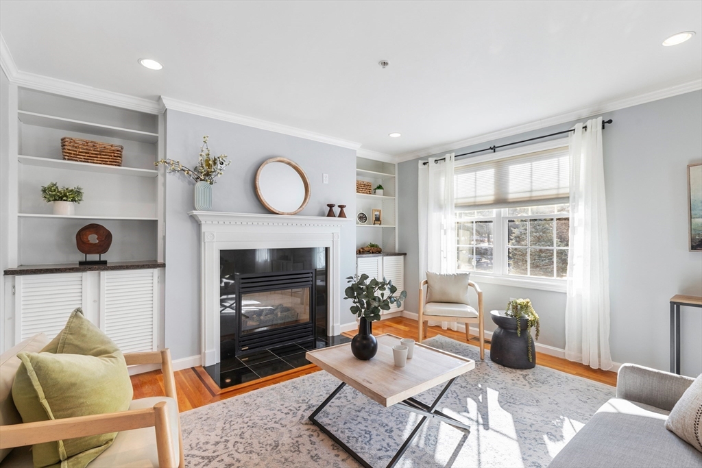 1005 Trapelo Road, Unit 8 Waltham, MA 02452 - Photo 8 of 24 a living room with furniture and a fireplace
