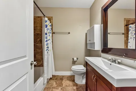 a bathroom with a sink toilet and shower