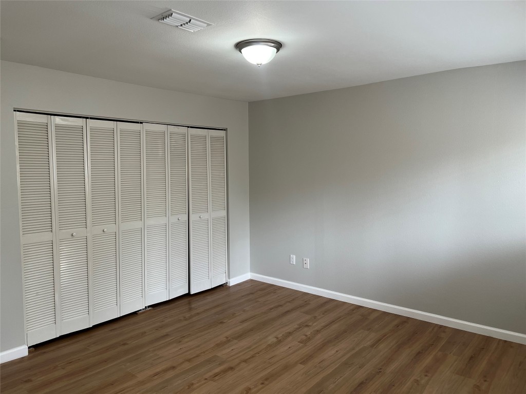 65 Yewleaf Road The Woodlands, TX 77381 - Photo 13 of 21 a view of an empty room with wooden floor