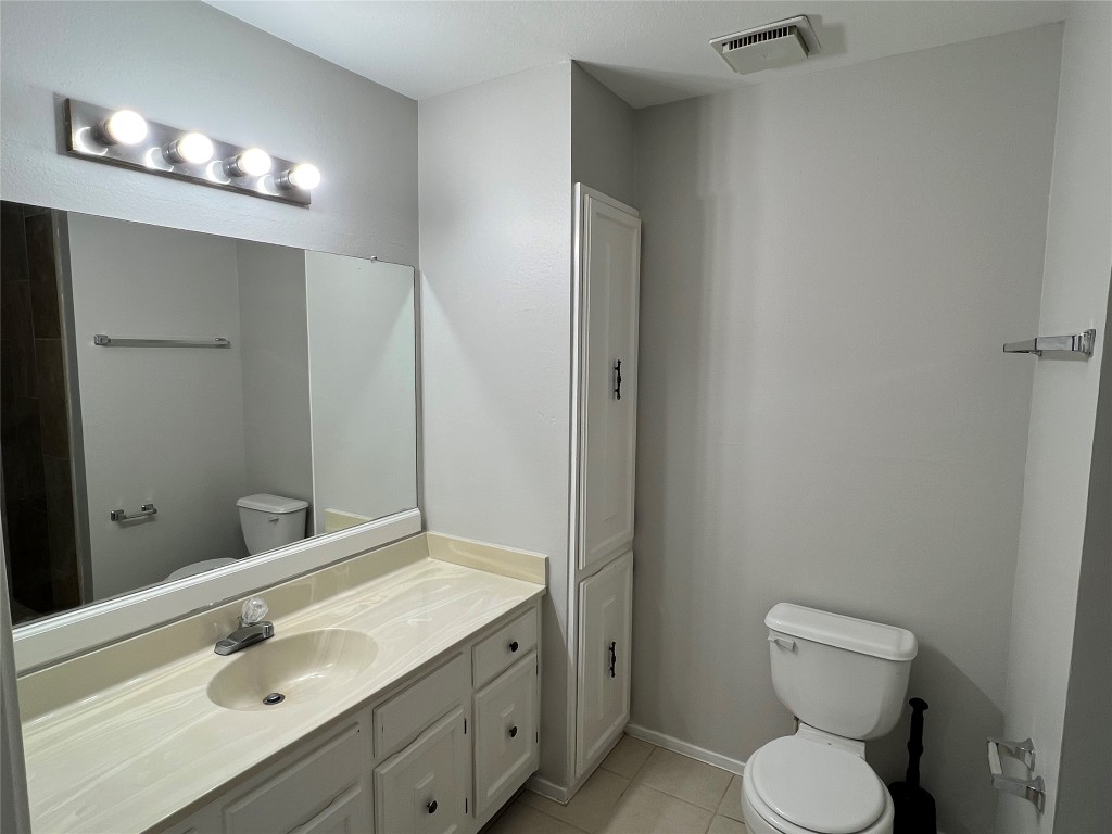 65 Yewleaf Road The Woodlands, TX 77381 - Photo 14 of 21 a bathroom with a toilet sink double vanity and mirror
