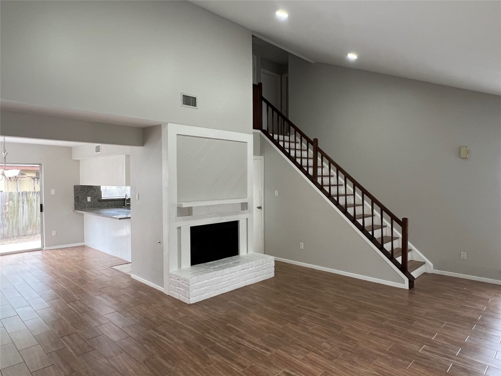 65 Yewleaf Road The Woodlands, TX 77381 - Photo 2 of 21 a view of an empty room with wooden floor a fireplace and entryway