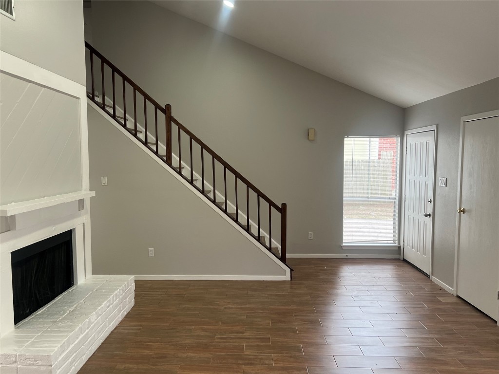 65 Yewleaf Road The Woodlands, TX 77381 - Photo 3 of 21 a view of an empty room with wooden floor and a window