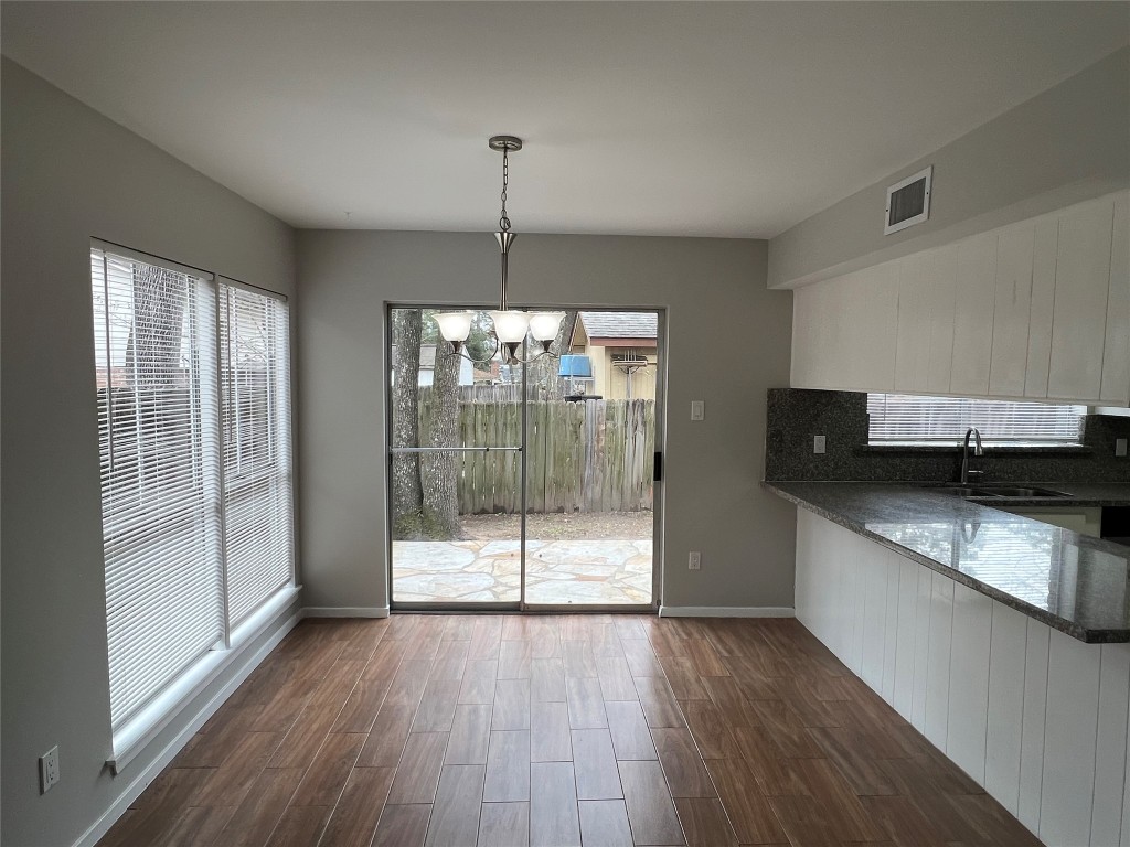 65 Yewleaf Road The Woodlands, TX 77381 - Photo 4 of 21 a kitchen with stainless steel appliances granite countertop a refrigerator a sink and wooden floors