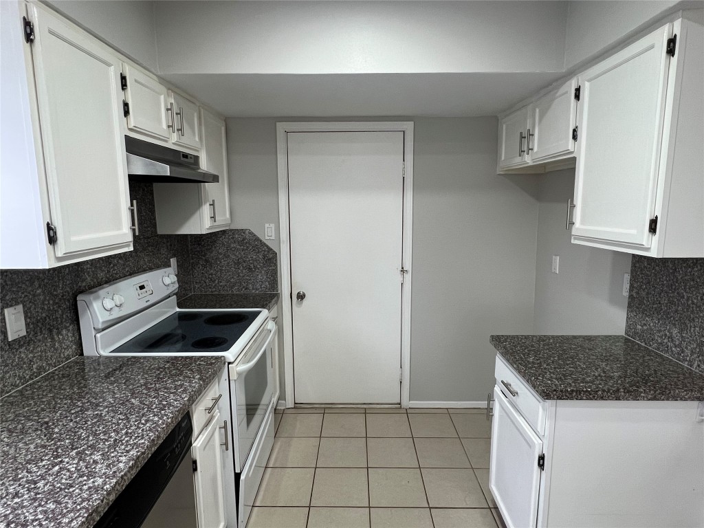 65 Yewleaf Road The Woodlands, TX 77381 - Photo 7 of 21 a kitchen with granite countertop a sink and a stove