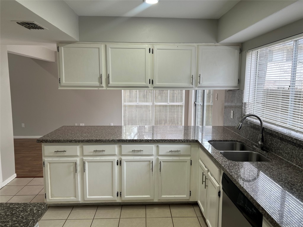 65 Yewleaf Road The Woodlands, TX 77381 - Photo 8 of 21 a kitchen with granite countertop white cabinets and sink