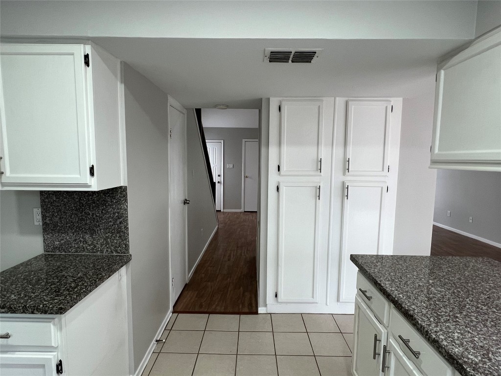 65 Yewleaf Road The Woodlands, TX 77381 - Photo 9 of 21 a kitchen with white cabinets a sink and dishwasher