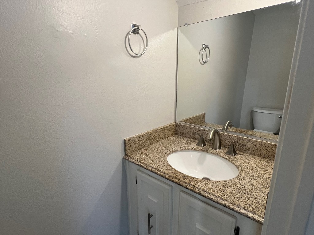 65 Yewleaf Road The Woodlands, TX 77381 - Photo 10 of 21 a bathroom with a granite countertop sink and a mirror