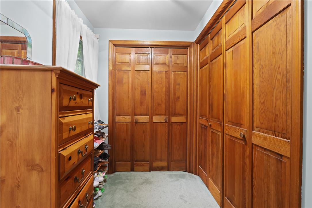 209 Remington Road East Stroudsburg, PA 18301 - Photo 26 of 41 Custom-crafted wooden built-ins and rich paneled doors define this organized closet space.
